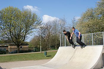 skate park ramp with kids in rollerblades